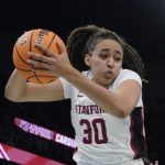 
              FILE - Stanford's Haley Jones grabs a rebound during the second half of a college basketball game against UConn in the semifinal round of the Women's Final Four NCAA tournament Friday, April 1, 2022, in Minneapolis. Jones was named to the women's Associated Press preseason All-America team, Tuesday, Oct. 25, 2022.(AP Photo/Charlie Neibergall, File)
            