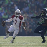 Arizona Cardinals quarterback Kyler Murray (1) scrambles away from Seattle Seahawks linebacker Boye Mafe (53) during the second half of an NFL football game in Seattle, Sunday, Oct. 16, 2022. (AP Photo/Abbie Parr)