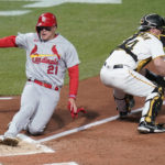 
              St. Louis Cardinals' Lars Nootbaar (21) scores next to Pittsburgh Pirates catcher Tyler Heineman on a two-run single by Albert Pujols during the third inning of a baseball game Tuesday, Oct. 4, 2022, in Pittsburgh. (AP Photo/Keith Srakocic)
            