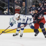 Tampa Bay Lightning's Brandon Hagel, left, and Columbus Blue Jackets' Yegor Chinakhov chase the puck during the third period of an NHL hockey game Friday, Oct. 14, 2022, in Columbus, Ohio. (AP Photo/Jay LaPrete)