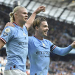 Manchester City's Erling Haaland, left, celebrates with his teammate Jack Grealish after scoring his side's fifth goal and his personal hat trick during the English Premier League soccer match between Manchester City and Manchester United at Etihad stadium in Manchester, England, Sunday, Oct. 2, 2022. (AP Photo/Rui Vieira)