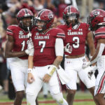 South Carolina quarterback Spencer Rattler (7) celebrates with wide receivers Jalen Brooks (13), Antwane Wells Jr. (3) and Ahmarean Brown (10) after a touchdown during the first half of an NCAA college football game against Missouri, Saturday, Oct. 29, 2022, in Columbia, S.C. (AP Photo/Artie Walker Jr.)
