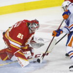 Calgary Flames goalie Jacob Markstrom makes a save against Edmonton Oilers' Kailer Yamamoto during the second period of an NHL hockey game in Calgary, Alberta, Saturday, Oct. 29, 2022. (Larry MacDougal/The Canadian Press via AP)