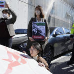 
              Protesters stage a rally to support Iranian competitive climber Elnaz Rekabi, outside the Iranian Embassy in Seoul, South Korea, Wednesday, Oct. 19, 2022. Rekabi received a hero's welcome on her return to Tehran early Wednesday, after competing in South Korea without wearing a mandatory headscarf required of female athletes from the Islamic Republic. (AP Photo/Ahn Young-joon)
            