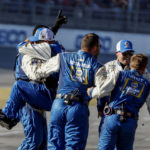 
              Chase Elliott's crew celebrates after winning a NASCAR Cup Series auto race Sunday, Oct. 2, 2022, in Talladega, Ala. (AP Photo/Butch Dill)
            