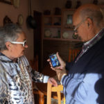 
              The parents of Santiago Sanchez Cogedor, Celia Cogedor, left, and Santiago Sanchez show a family photo of their son on a phone in their home in Henches, Spain, Monday, Oct. 24, 2022. A Spanish man who was documenting his ambitious journey by foot from Madrid to Doha for the 2022 FIFA World Cup has not been heard from since crossing into Iran three weeks ago, his family said Monday, stirring fears about his fate in a country convulsed by mass unrest.  (AP Photo/Paul White)
            