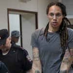 
              FILE - WNBA star and two-time Olympic gold medalist Brittney Griner is escorted from a courtroom after a hearing in Khimki just outside Moscow, Russia, on Aug. 4, 2022. The Moscow region's court on Monday Oct. 3, 2022 set a date for American basketball star Brittney Griner's appeal against her nine-year prison sentence for drug possession, scheduling the hearing for Oct. 25. (AP Photo/Alexander Zemlianichenko, File)
            