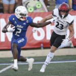 Tulsa's Keylon Stokes runs away from Cincinnati's Drew Donley during the first half of an NCAA college football game in Tulsa, Okla., Saturday, Oct. 1, 2022. (AP Photo/Dave Crenshaw)
