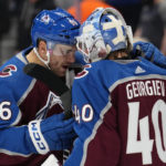 Colorado Avalanche right wing Mikko Rantanen (96) and goaltender Alexandar George (40) celebrate a 2-1 win against the Dallas Stars following an NHL preseason hockey game Wednesday, Oct. 5, 2022, in Denver. (AP Photo/Jack Dempsey)