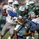 
              Tulane running back Shaadie Clayton (0) is tackled by Memphis defensive backs Quindell Johnson (15) and Ladarian Paulk (23) during the first half of an NCAA college football in New Orleans, Saturday, Oct. 22, 2022. (AP Photo/Tyler Kaufman)
            