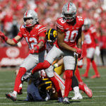 
              Ohio State defenders Lathan Ransom, left, and Xavier Johnson celebrate stopping Iowa on fourth down during the first half of an NCAA college football game Saturday, Oct. 22, 2022, in Columbus, Ohio. (AP Photo/Jay LaPrete)
            