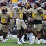 Arizona State's Macen Williams (6), Charles Hall IV (0), Xazavian Valladay (1) and Matthew Pola Mao (95) celebrate during the closing moments of the second half of an NCAA college football game against Washington in Tempe, Ariz., Saturday, Oct. 8, 2022. (AP Photo/Ross D. Franklin)
