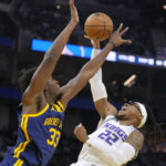 Sacramento Kings center Richaun Holmes (22) reacts as he is fouled by Golden State Warriors center James Wiseman (33) during the first half of an NBA basketball game on Sunday, Oct. 23, 2022 in San Francisco. (AP Photo/Tony Avelar)