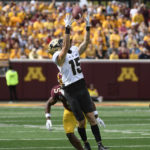 
              Purdue wide receiver Charlie Jones (15) catches a 28-yard pass while defended by Minnesota defensive back Justin Walley (5) during the second half of an NCAA college football game, Saturday, Oct. 1, 2022, in Minneapolis. Purdue won 20-10. (AP Photo/Craig Lassig)
            