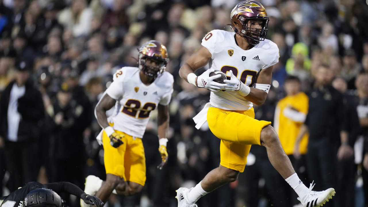 Arizona State tight end Messiah Swinson, right, breaks free from a tackle by Colorado safety Tyrin ...