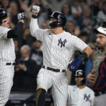 New York Yankees Anthony Rizzo, left, celebrates with Aaron Judge after hitting a two-run home run against the Cleveland Guardians during the sixth inning of Game 1 of an American League Division baseball series, Tuesday, Oct. 11, 2022, in New York. (AP Photo/John Minchillo)