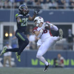 Arizona Cardinals tight end Zach Ertz, right, catches a pass in front of Seattle Seahawks safety Ryan Neal during the second half of an NFL football game in Seattle, Sunday, Oct. 16, 2022. (AP Photo/Caean Couto)