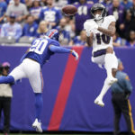 
              New York Giants safety Julian Love (20) and Baltimore Ravens' Demarcus Robinson (10) fight for control of the ball during the first half of an NFL football game Sunday, Oct. 16, 2022, in East Rutherford, N.J. The pass was incomplete. (AP Photo/John Minchillo)
            