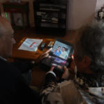 
              The parents of Santiago Sanchez Cogedor, Celia Cogedor, right, and Santiago Sanchez show a photo of their son with their daughter Natalia in a photo album in their home in Henches, Spain, Monday, Oct. 24, 2022. A Spanish man who was documenting his ambitious journey by foot from Madrid to Doha for the 2022 FIFA World Cup has not been heard from since crossing into Iran three weeks ago, his family said Monday, stirring fears about his fate in a country convulsed by mass unrest. (AP Photo/Paul White)
            