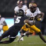 Colorado safety Tyrin Taylor, left, tackles Arizona State wide receiver Bryan Thompson after a short gain in the second half of an NCAA college football game Saturday, Oct. 29, 2022, in Boulder, Colo. (AP Photo/David Zalubowski)