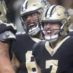 New Orleans Saints' Taysom Hill, right, celebrates his 60 yard rushing touchdown with Erik McCoy, left, and J.P. Holtz during an NFL football game against the Seattle Seahawks in New Orleans, Sunday, Oct. 9, 2022. (AP Photo/Gerald Herbert)
