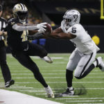 
              New Orleans Saints running back Alvin Kamara (41) reaches for a marker as Las Vegas Raiders linebacker Divine Deablo (5) pushes him out during the first half of an NFL football game Sunday, Oct. 30, 2022, in New Orleans. (AP Photo/Butch Dill)
            