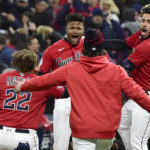 Cleveland Guardians' Oscar Gonzalez, second from left, is greeted by teammates after he drove in the winning run in the ninth inning of Game 3 of the baseball team's AL Division Series against the New York Yankees, Saturday, Oct. 15, 2022, in Cleveland. The Guardians won 6-5. (AP Photo/Phil Long)