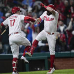 Philadelphia Phillies' Kyle Schwarber celebrates his home run with Rhys Hoskins during the sixth inning in Game 4 of the baseball NL Championship Series between the San Diego Padres and the Philadelphia Phillies on Saturday, Oct. 22, 2022, in Philadelphia. (AP Photo/Matt Rourke)