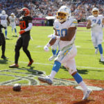 
              Los Angeles Chargers running back Austin Ekeler (30) spikes the ball after running in for a touchdown against the Cleveland Browns during the first half of an NFL football game, Sunday, Oct. 9, 2022, in Cleveland. (AP Photo/Ron Schwane)
            