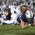 Penn State tight end Tyler Warren (44) dives past Minnesota defensive back Tyler Nubin (27) to score a first-half touchdown during an NCAA college football game Saturday, Oct. 22, 2022, in State College, Pa. (AP Photo/Barry Reeger)