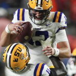 LSU quarterback Garrett Nussmeier (13) celebrates with defensive end Ali Gaye (11) after defeating Auburn in the second half of an NCAA college football game Saturday, Oct. 1, 2022, in Auburn, Ala. (AP Photo/John Bazemore)