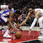 Philadelphia 76ers guard De'Anthony Melton, center, chases a loose ball against Chicago Bulls forward Javonte Green, left, and guard Zach LaVine during the first half of an NBA basketball game Saturday, Oct. 29, 2022, in Chicago. (AP Photo/Matt Marton)
