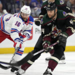 Arizona Coyotes right wing Zack Kassian (44) tries to keep the puck away from New York Rangers center Vincent Trocheck (16) during the first period of an NHL hockey game at Mullett Arena in Tempe, Ariz., Sunday, Oct. 30, 2022. (AP Photo/Ross D. Franklin)
