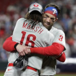 Philadelphia Phillies' Brandon Marsh (16) and Bryce Harper (3) celebrate after the Phillies defeated the St. Louis Cardinals 2-0 in Game 2 of an NL wild-card baseball playoff series Saturday, Oct. 8, 2022, in St. Louis. The Phillies advanced to an NL Division Series against the Atlanta Braves. (AP Photo/Scott Kane)