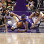 
              Golden State Warriors forward Andrew Wiggins and Charlotte Hornets forward Jalen McDaniels dive for the ball during the first half of an NBA basketball game on Saturday, Oct. 29, 2022, in Charlotte, N.C. (AP Photo/Scott Kinser)
            