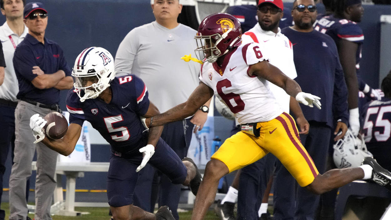 Arizona wide receiver Dorian Singer tries to make the catch in front of Southern California defensi...