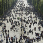 
              FILE- Visitors walk towards planted fields on the Champs Elysees near the "Place de la Concorde" (Concorde's square) monument in Paris, Sunday, May 23, 2010. Some 4,400 of the world's best athletes, parading down France's most famous boulevard with their prosthetic limbs, mobility chairs and stories of adversities overcome, to a grand celebration of their prowess and sports on the Paris square where the French revolutionaries of 1789 chopped off heads. (AP Photo/Jacques Brinon, File)
            