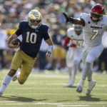 
              Notre Dame quarterback Drew Pyne (10) runs the ball toward the end zone during the second quarter of an NCAA college football game against UNLV, Saturday, Oct. 22, 2022, in South Bend, Ind. (AP Photo/Marc Lebryk)
            