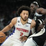 Detroit Pistons guard Cade Cunningham (2) tries to get past Milwaukee Bucks guard Jrue Holiday (21) during the first half of an NBA basketball game Monday, Oct. 31, 2022, in Milwaukee. (AP Photo/Morry Gash)