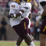 Arizona State defensive back Jordan Clark (1) is congratulated by defensive lineman Omarr Norman-Lott (55) after intercepting a pass against Stanford during the first half of an NCAA college football game in Stanford, Calif., Saturday, Oct. 22, 2022. (AP Photo/Jeff Chiu)