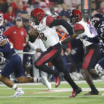 
              San Diego State quarterback Jalen Mayden heads in for a touchdown as Fresno State defensive back Bralyn Lux, left, and defensive back LJ Early look on during the first half of an NCAA college football game in Fresno, Calif., Saturday, Oct. 29, 2022. (AP Photo/Gary Kazanjian)
            