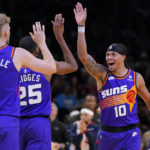 Phoenix Suns guard Damion Lee (10) high fives forward Mikal Bridges (25) during the second half of an NBA basketball game against the New Orleans Pelicans, Friday, Oct. 28, 2022, in Phoenix. (AP Photo/Matt York)