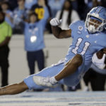 North Carolina wide receiver Josh Downs (11) falls to the turf after making a reception for a touchdown during the second half of an NCAA college football game against Pittsburgh in Chapel Hill, N.C., Saturday, Oct. 29, 2022. (AP Photo/Chris Seward)