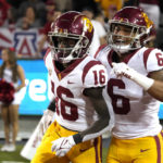 Southern California wide receiver Tahj Washington (16) celebrates with running back Austin Jones (6) after scoring a touchdown against Arizona in the second half during an NCAA college football game, Saturday, Oct. 29, 2022, in Tucson, Ariz. (AP Photo/Rick Scuteri)