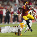 Southern California wide receiver Mario Williams, right, breaks a tackle by Arizona State defensive back Khoury Bethley, left, during the first half of an NCAA college football game Saturday, Oct. 1, 2022, in Los Angeles. (AP Photo/Mark J. Terrill)