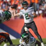 New York Jets quarterback Zach Wilson (2) works in the pocket against the Denver Broncos during the second half of an NFL football game, Sunday, Oct. 23, 2022, in Denver. (AP Photo/David Zalubowski)