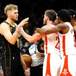 Phoenix Suns' Jock Landale, left and Houston Rockets' Josh Christopher, right, try to calm down Garrison Mathews, middle, after an altercation during the second half of an NBA basketball game, Sunday, Oct. 30, 2022, in Phoenix. (AP Photo/Darryl Webb)
