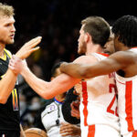 Phoenix Suns' Jock Landale, left and Houston Rockets' Josh Christopher, right, try to calm down Garrison Mathews, middle, after an altercation during the second half of an NBA basketball game, Sunday, Oct. 30, 2022, in Phoenix. (AP Photo/Darryl Webb)