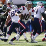 
              New England Patriots quarterback Mac Jones (10) carries the ball against the New York Jets during the first quarter of an NFL football game, Sunday, Oct. 30, 2022, in New York. (AP Photo/John Minchillo)
            