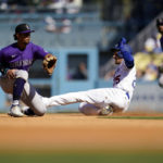 
              Los Angeles Dodgers' Trayce Thompson, front right, steals second base past Colorado Rockies shortstop Ezequiel Tovar, left, during the fifth inning of a baseball game Sunday, Oct. 2, 2022, in Los Angeles. (AP Photo/Marcio Jose Sanchez)
            